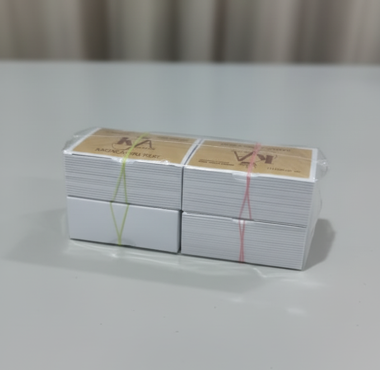 Stack of white cards with red and yellow text on a gray surface