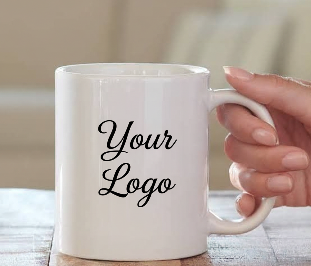 White mug with 'Your Logo' text held by a hand on a wooden surface.