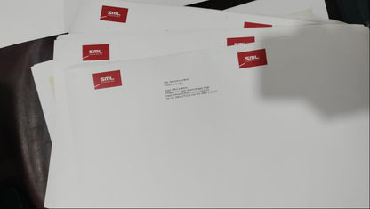 White paper with red labels on a dark surface