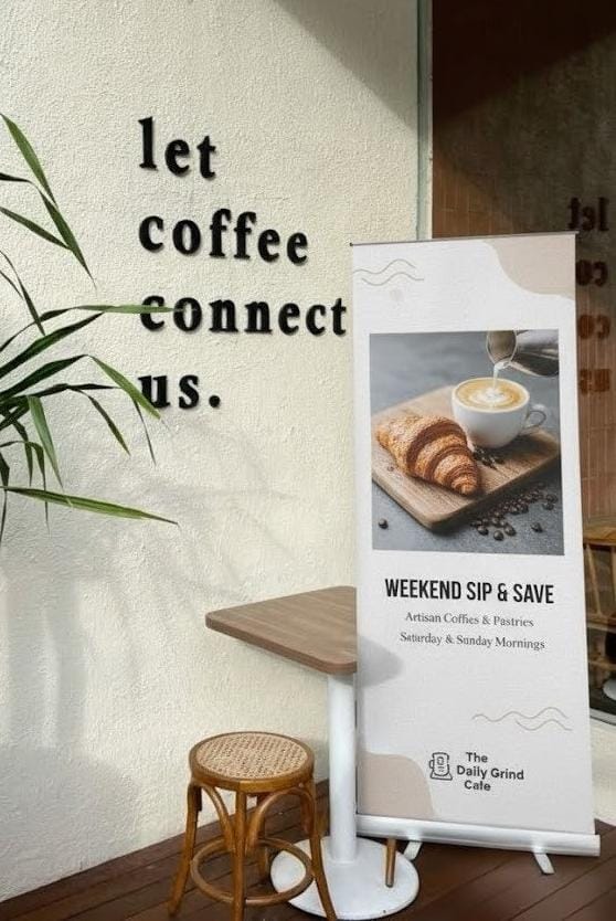 Roll-up banner with coffee-themed design in a cafe setting