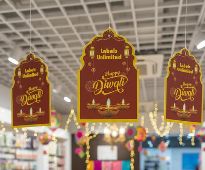 Decorative hanging signs with 'Happy Diwali' text in a store setting.