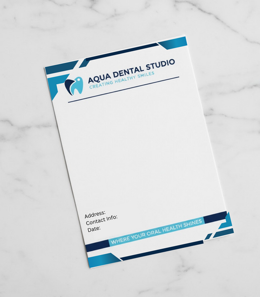 Letterhead for Aqua Dental Studio on a marble surface