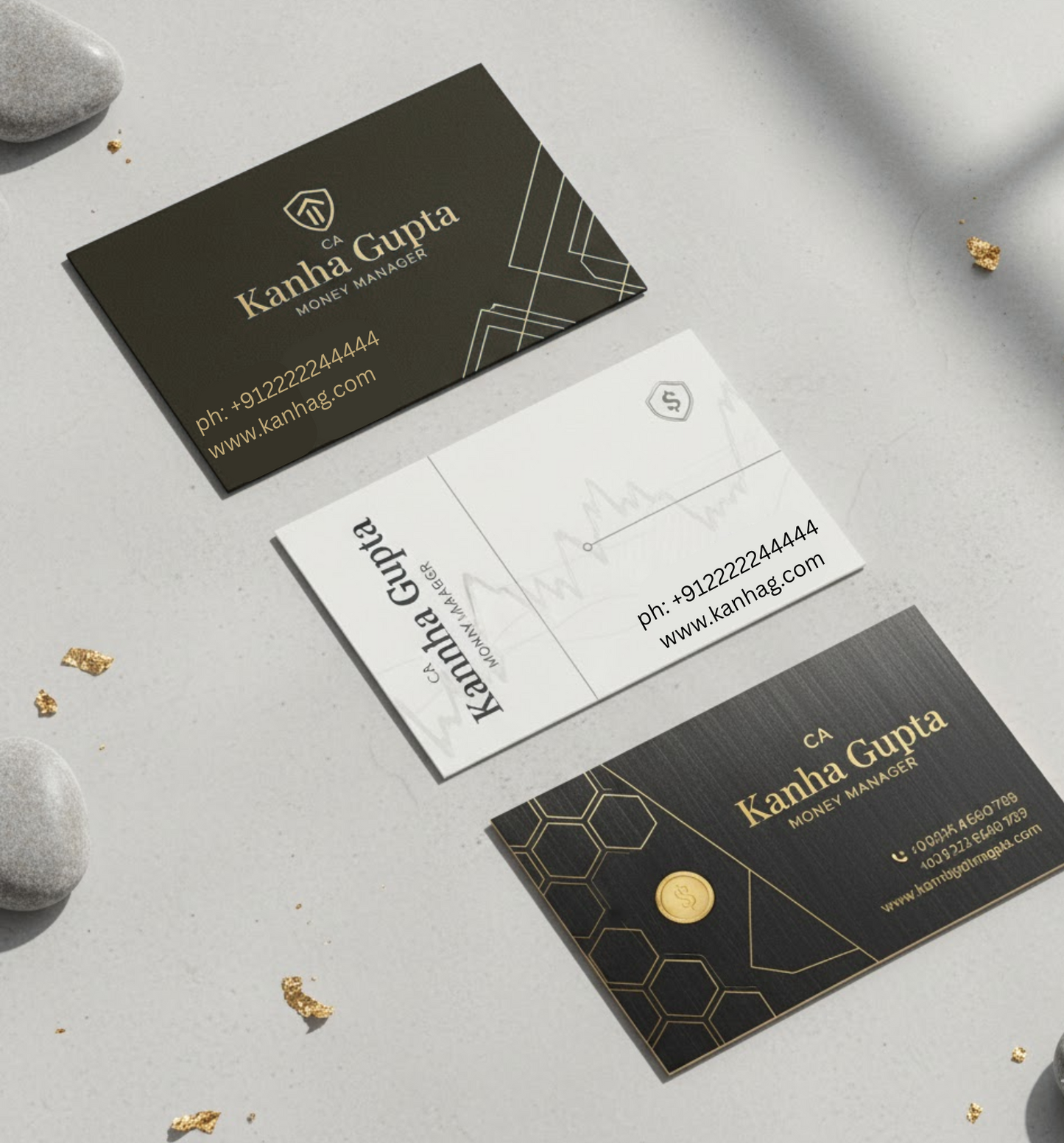 Three black business cards with gold accents on a gray surface.